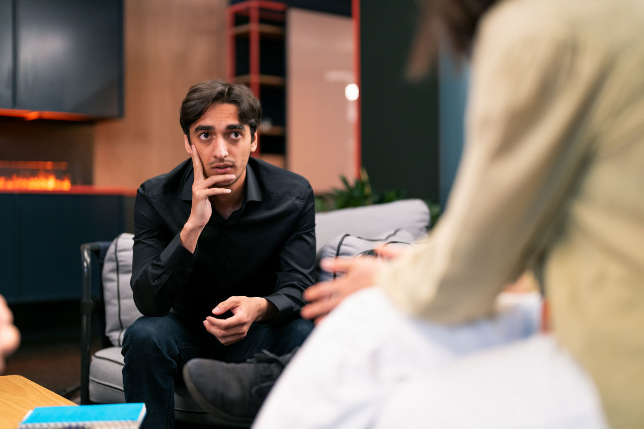 Man listening to a team conversation