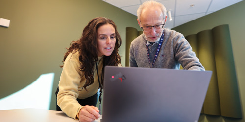 Man and woman looking at computer